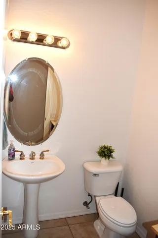 a bathroom with a sink mirror and toilet