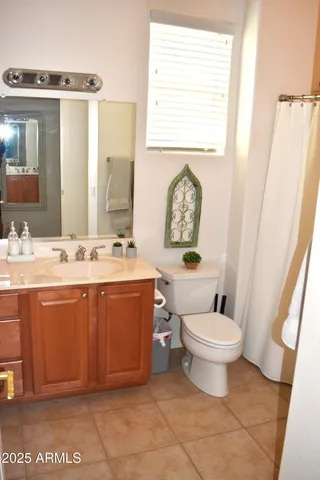 a living room with furniture and a wall painting