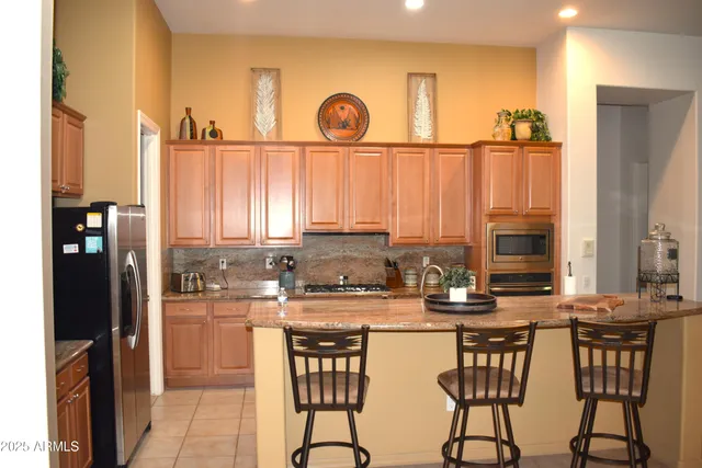 a kitchen with a large window and cabinets