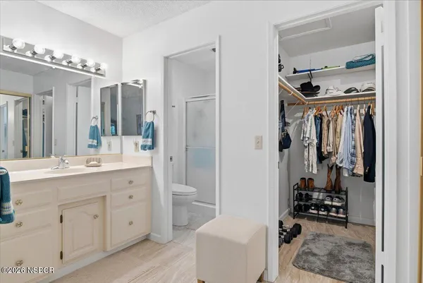 a bedroom with bed and a large mirror