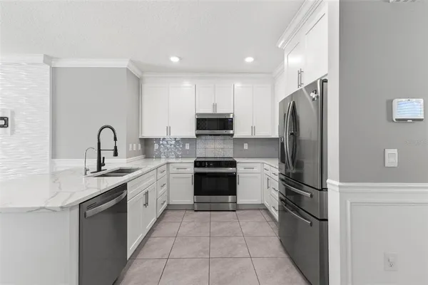 a kitchen with a refrigerator sink and oven