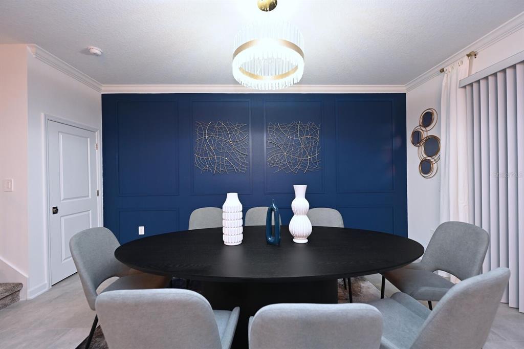 2956 Penelope Loop Kissimmee, FL 34746 - Photo 29 of 94 a view of a dining room with furniture and wooden floor