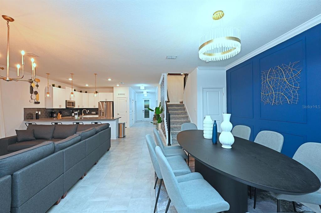 2956 Penelope Loop Kissimmee, FL 34746 - Photo 4 of 94 a large kitchen with a table and chairs