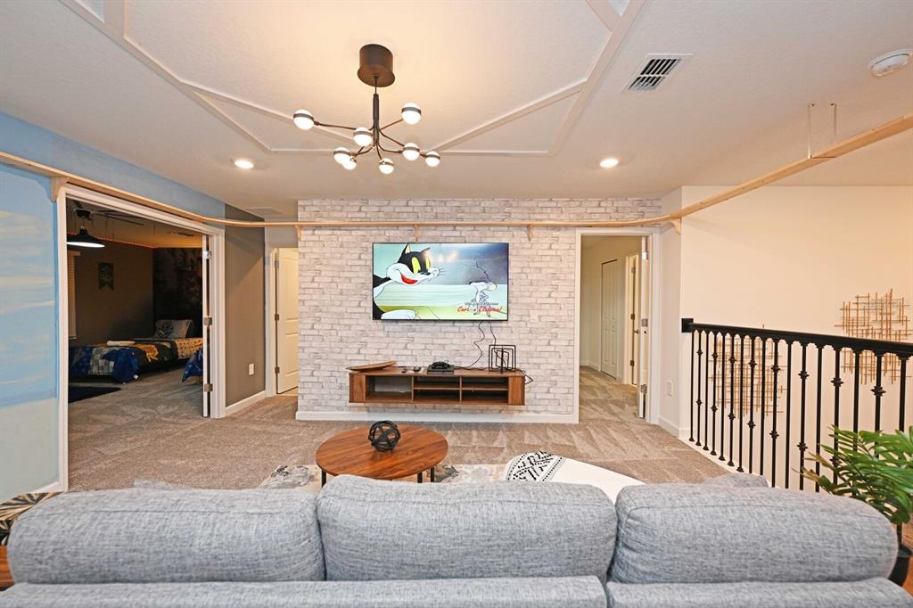 2956 Penelope Loop Kissimmee, FL 34746 - Photo 51 of 94 a living room with furniture and a chandelier