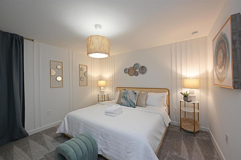 2956 Penelope Loop Kissimmee, FL 34746 - Photo 53 of 94 a bedroom with a bed and a mirror