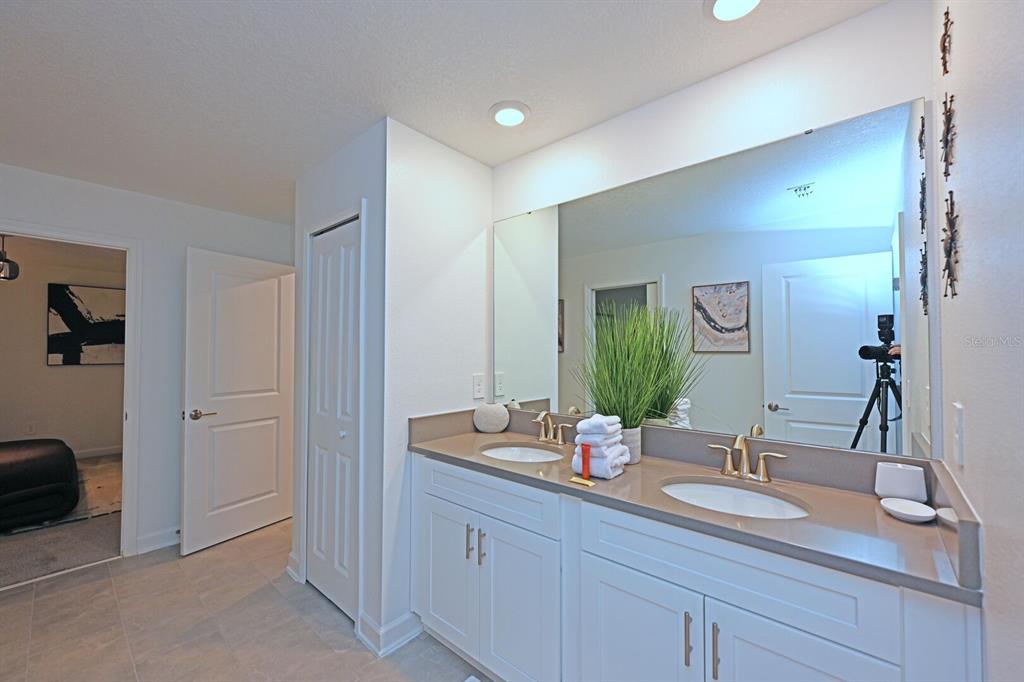2956 Penelope Loop Kissimmee, FL 34746 - Photo 60 of 94 a bathroom with a sink and a mirror