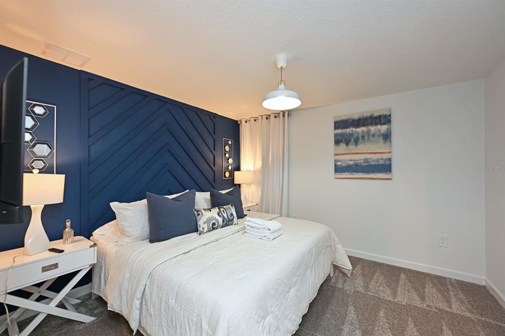 2956 Penelope Loop Kissimmee, FL 34746 - Photo 61 of 94 a bedroom with bed and a night stand