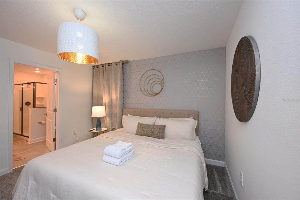 2956 Penelope Loop Kissimmee, FL 34746 - Photo 71 of 94 a bedroom with a bed and a lamp