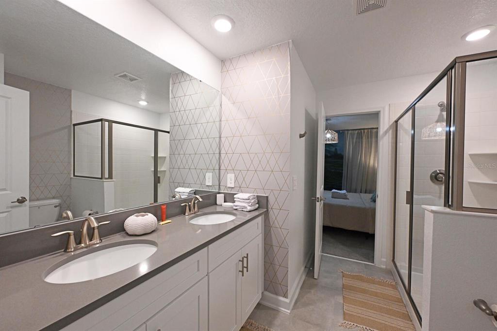 2956 Penelope Loop Kissimmee, FL 34746 - Photo 72 of 94 a bathroom with a double vanity sink mirror and double