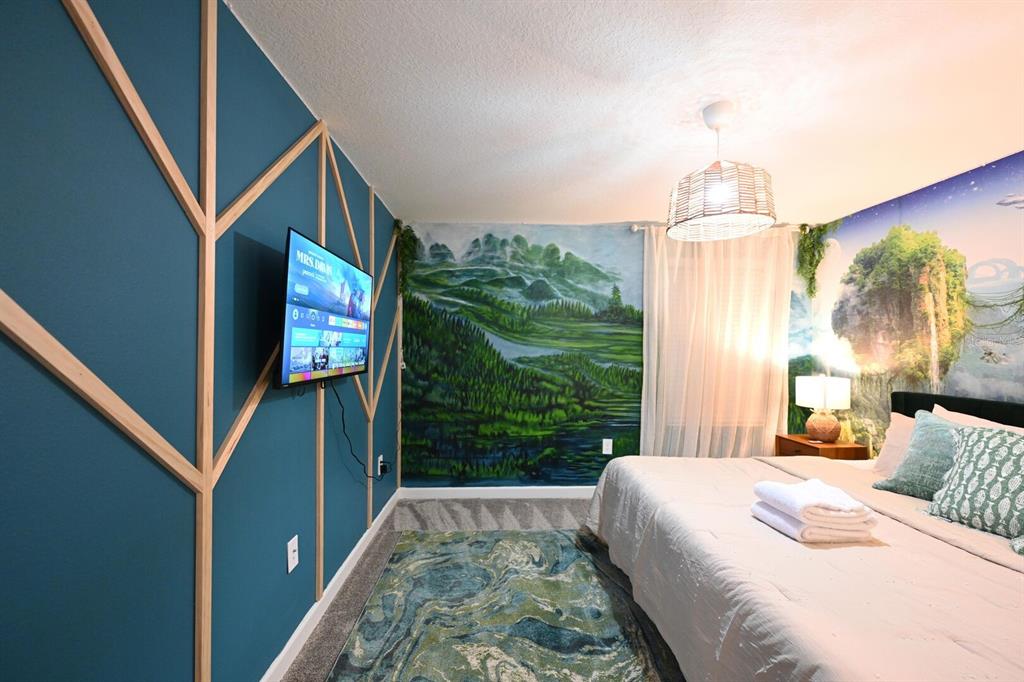 2956 Penelope Loop Kissimmee, FL 34746 - Photo 74 of 94 a bedroom with a bed and a flat screen tv