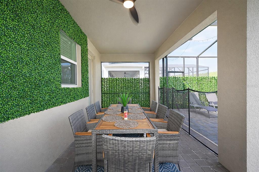 2956 Penelope Loop Kissimmee, FL 34746 - Photo 77 of 94 a view of a patio with a table chairs and a backyard