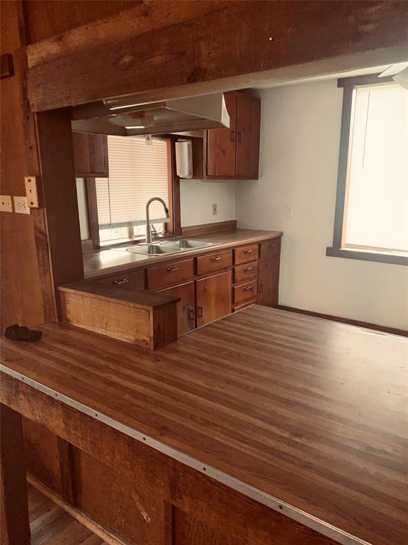 7046 Camp Street Azle, TX 76020 - Photo 23 of 26 a view of kitchen with wooden floor and window