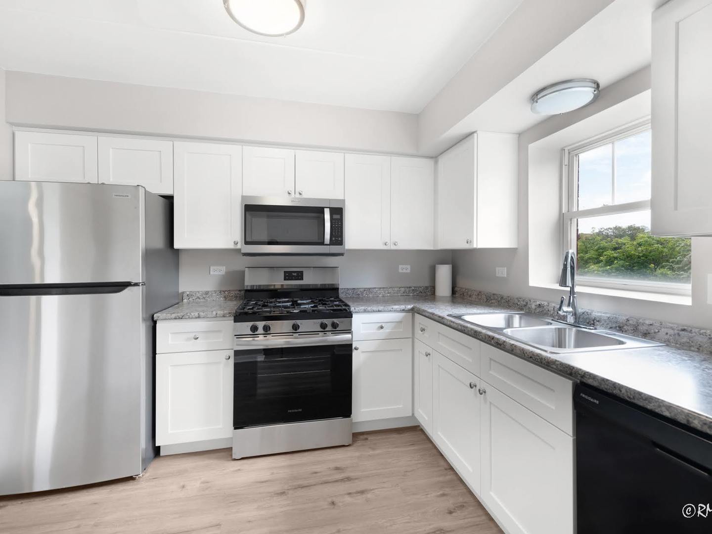 237 North Mill Road, Unit 12 Addison, IL 60101 - Photo 17 of 21 a kitchen with a sink a stove a refrigerator and a window