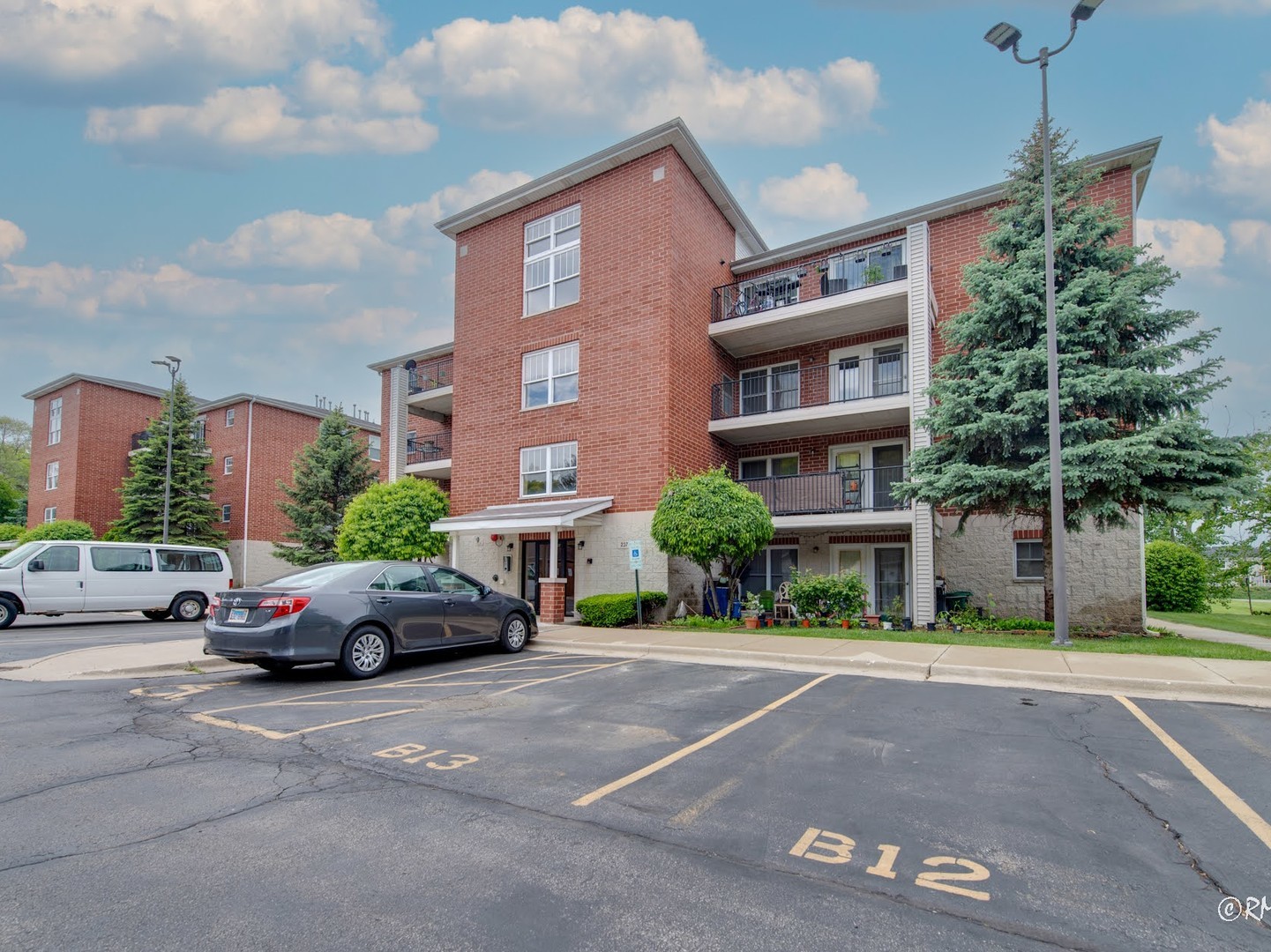 237 North Mill Road, Unit 12 Addison, IL 60101 - Photo 2 of 21 a cars parked in front of a building