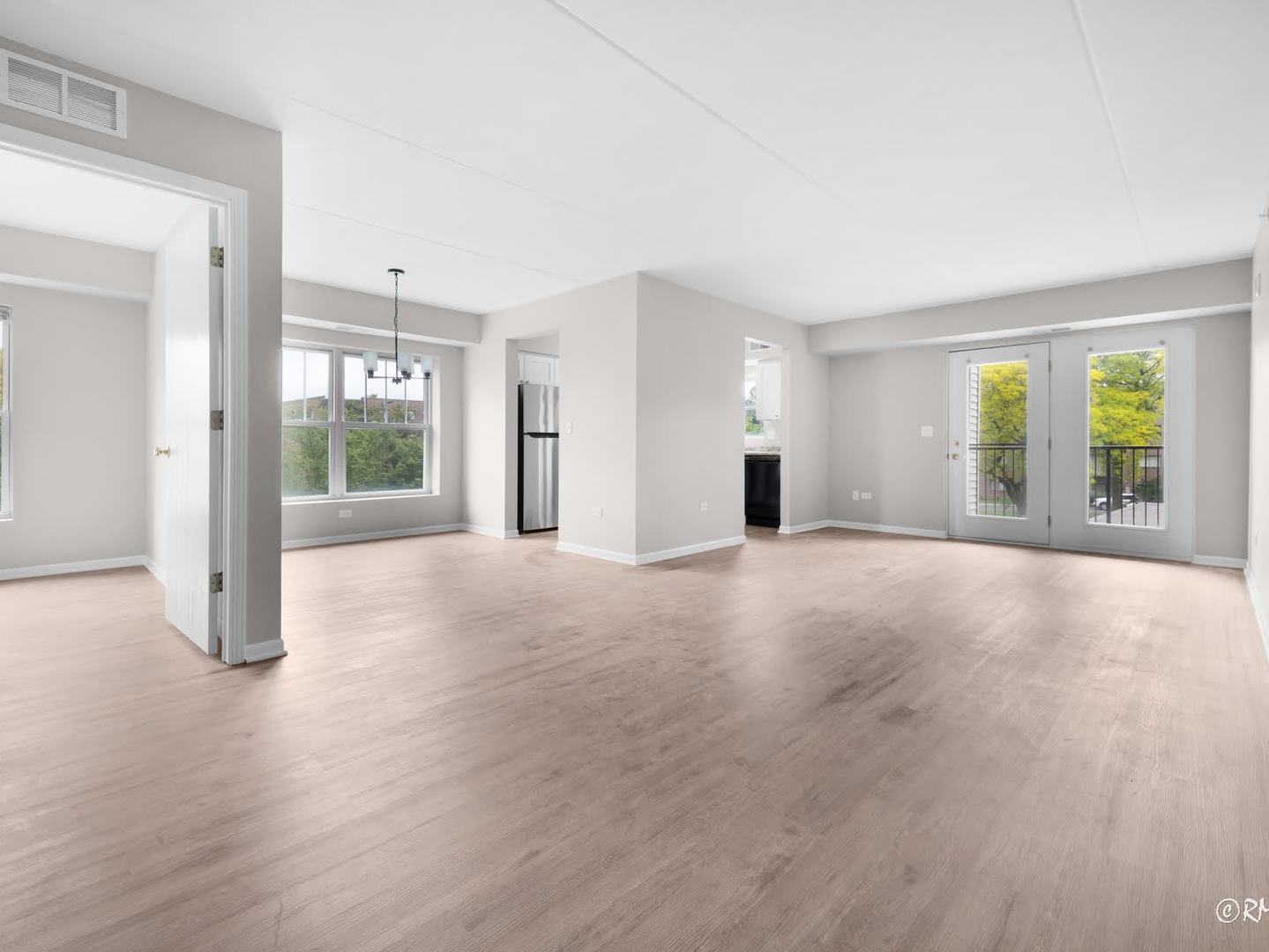 237 North Mill Road, Unit 12 Addison, IL 60101 - Photo 4 of 21 a view of a livingroom with wooden floor and windows