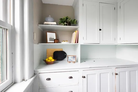 a kitchen with a cabinets and white cabinets