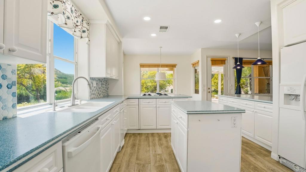 2527 Southern Oak Road Ramona, CA 92065 - Photo 19 of 56 a kitchen with a sink and large windows