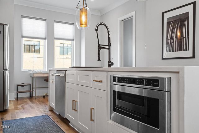 a kitchen with cabinets appliances and a window