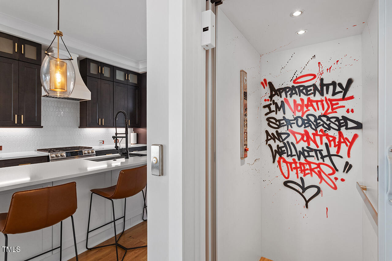 613 South West Street Raleigh, NC 27601 - Photo 17 of 36 a kitchen with stainless steel appliances granite countertop a stove and a refrigerator