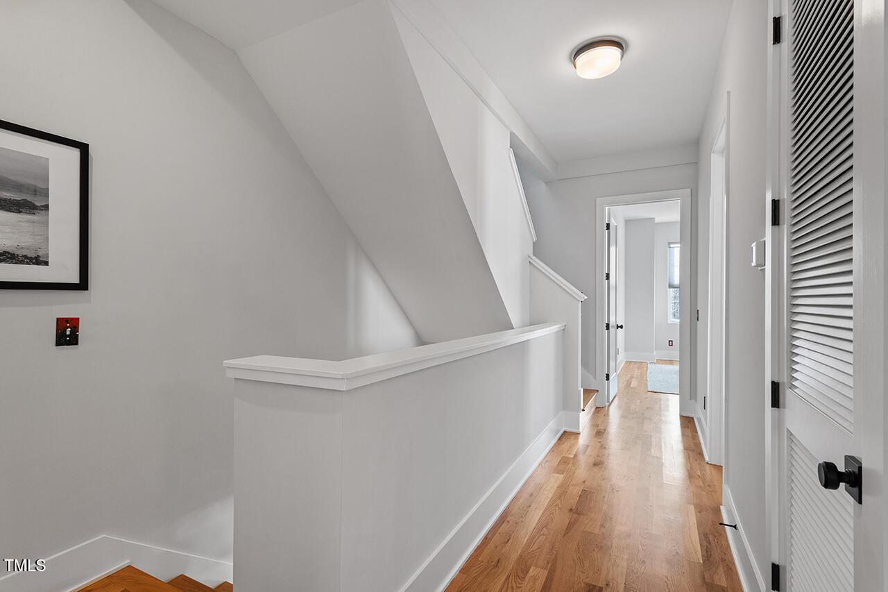 613 South West Street Raleigh, NC 27601 - Photo 20 of 37 a view of a hallway with wooden floor and staircase