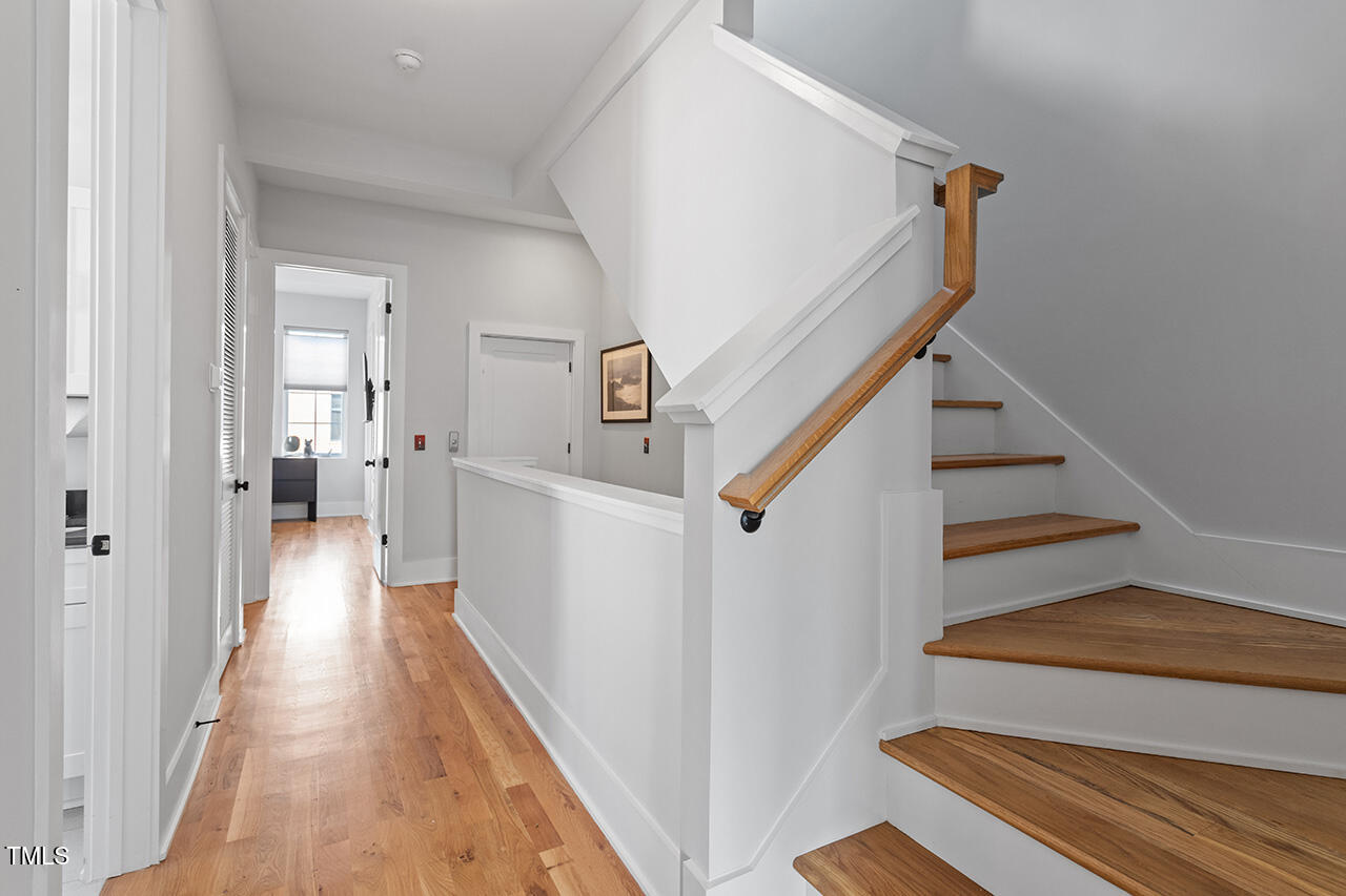 613 South West Street Raleigh, NC 27601 - Photo 21 of 37 a view of a hallway with wooden floor and staircase