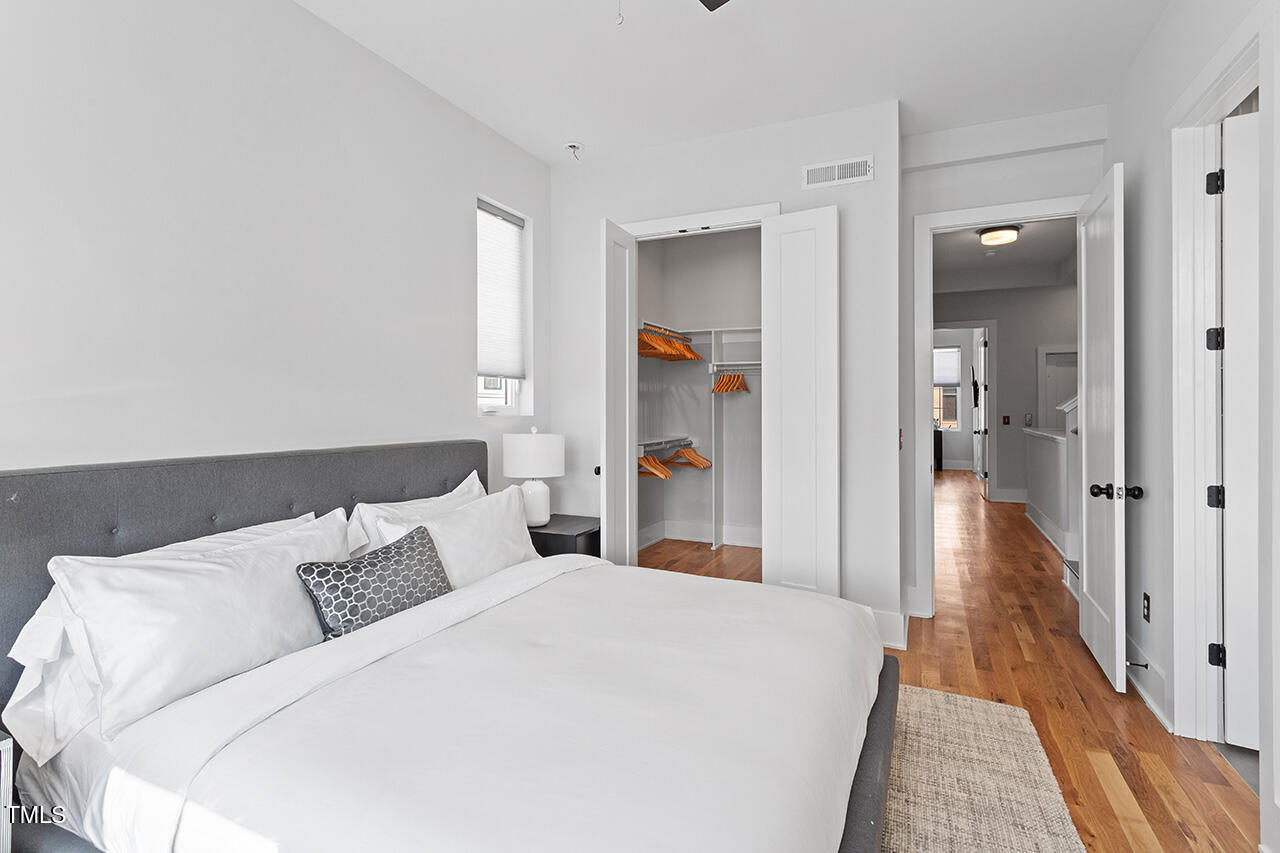 613 South West Street Raleigh, NC 27601 - Photo 25 of 36 a large white bed in a white room