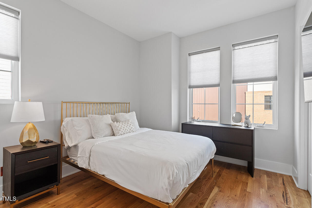 613 South West Street Raleigh, NC 27601 - Photo 29 of 36 a bedroom with a bed and a window