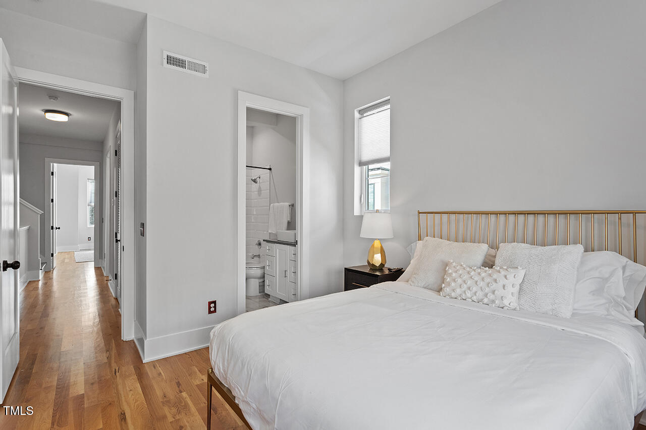 613 South West Street Raleigh, NC 27601 - Photo 30 of 36 a bedroom with a bed and wooden floor
