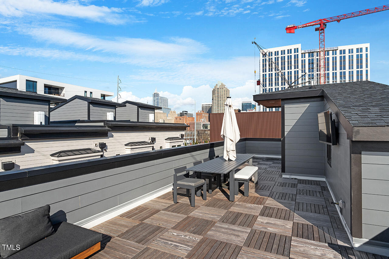 613 South West Street Raleigh, NC 27601 - Photo 34 of 37 a roof deck view with chairs and wooden floor