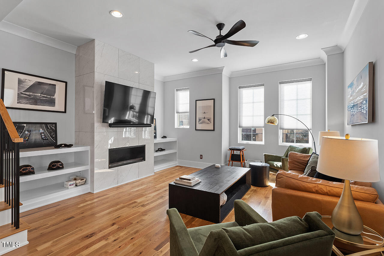 613 South West Street Raleigh, NC 27601 - Photo 5 of 37 a living room with furniture flat screen tv and a fireplace