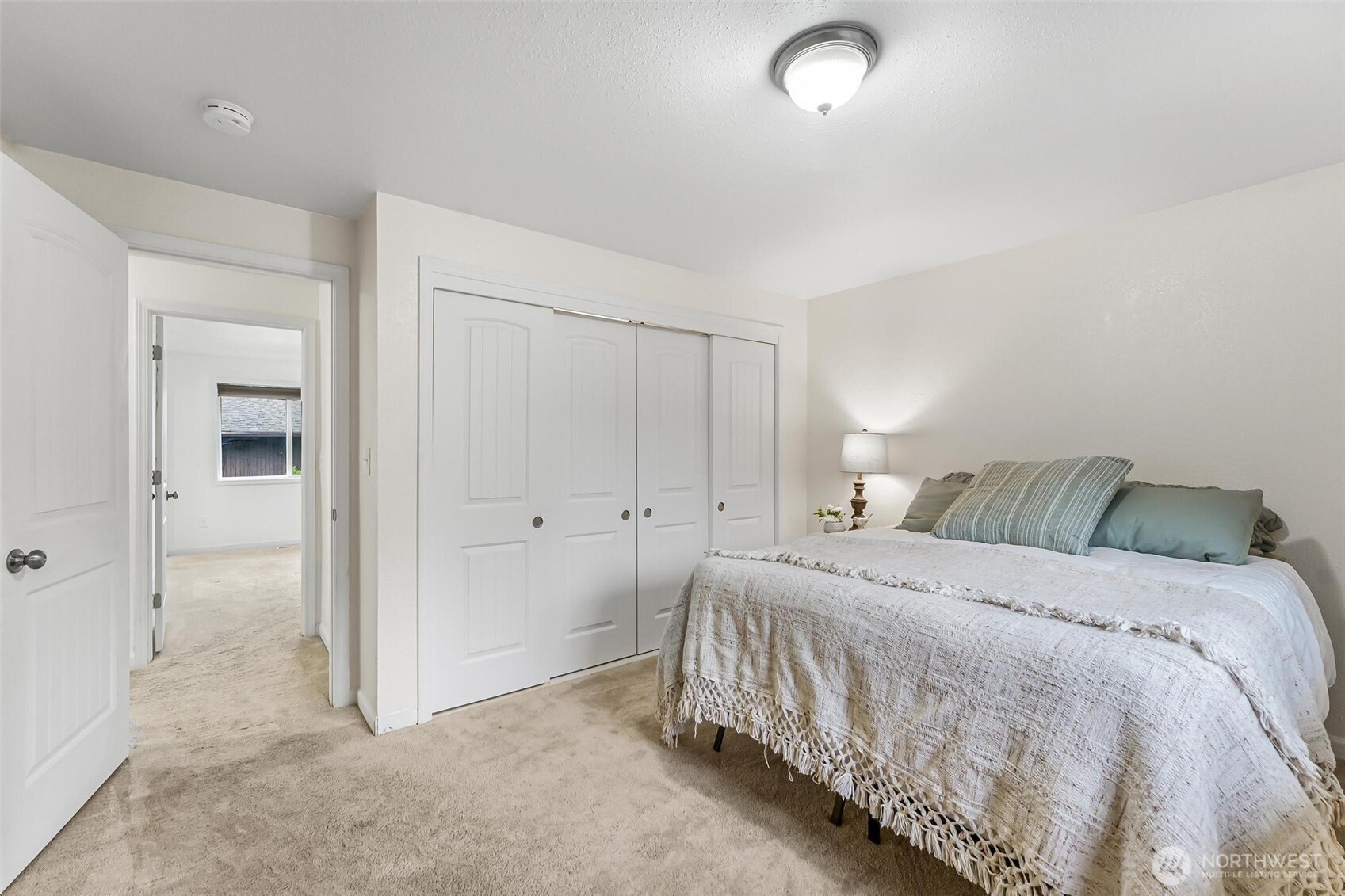 11404 Karshner Road East Edgewood, WA 98372 - Photo 22 of 40 a bedroom with a bed and a walk in closet