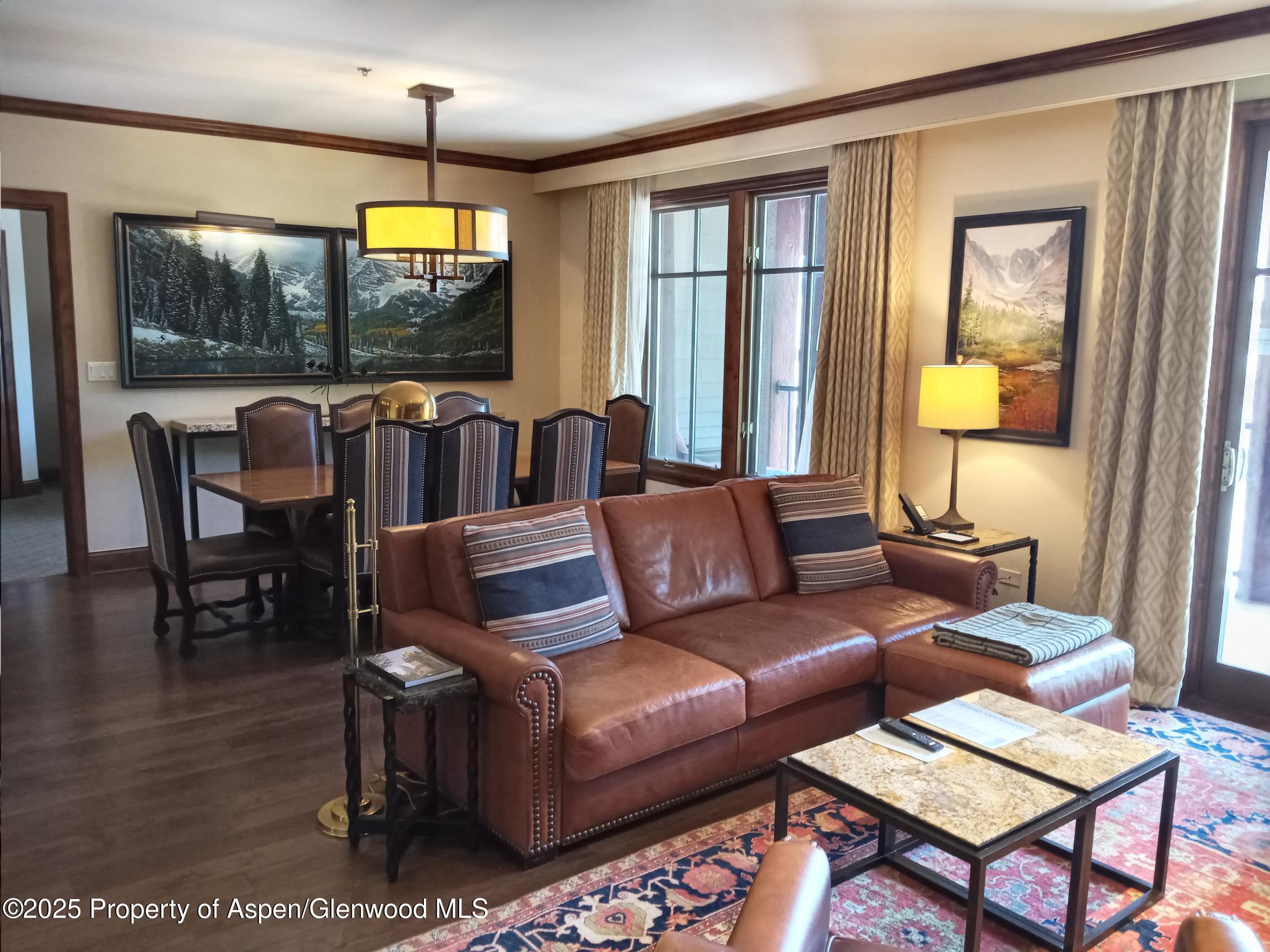 39 Boomerang Road, Unit 8209 SUMMER INTEREST 9 Aspen, CO 81611 - Photo 22 of 26 a living room with furniture a window and a flat screen tv