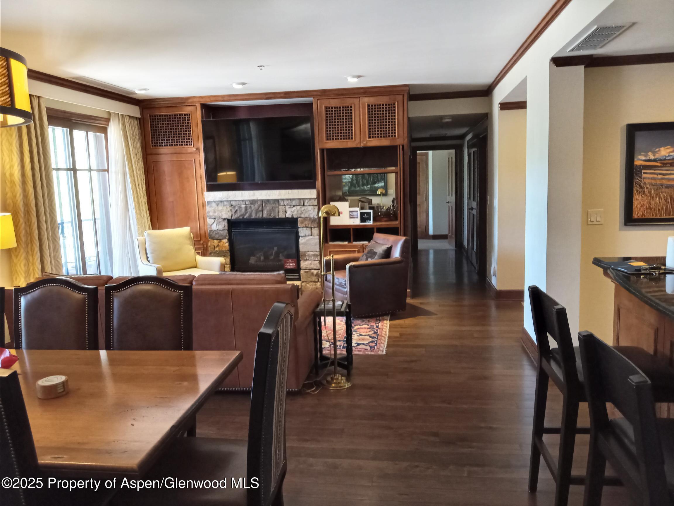 39 Boomerang Road, Unit 8209 SUMMER INTEREST 9 Aspen, CO 81611 - Photo 23 of 26 a living room with fireplace furniture and a flat screen tv