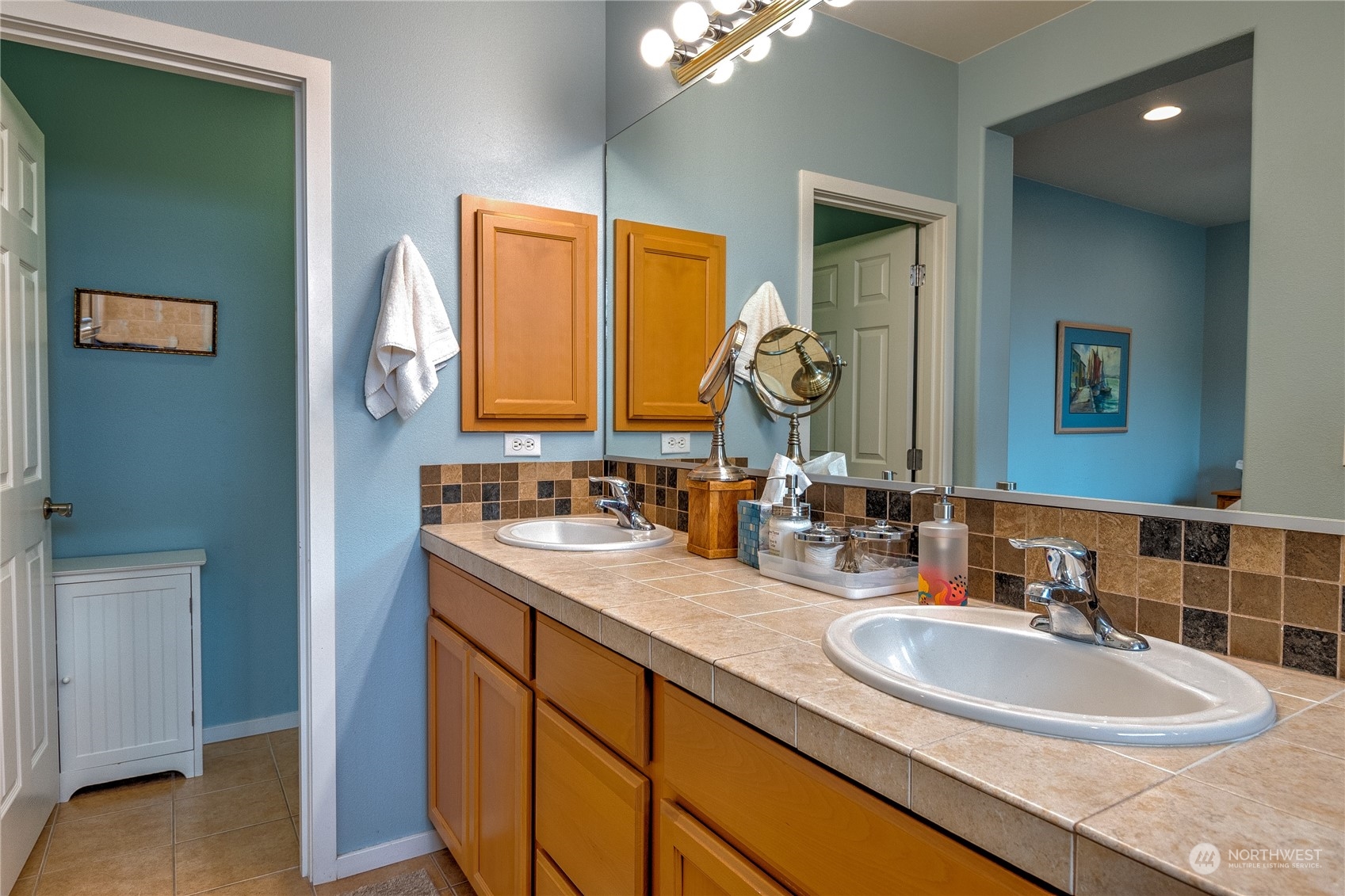 8024 Mercer Court Northeast Lacey, WA 98516 - Photo 15 of 30 a bathroom with a double vanity sink and a mirror