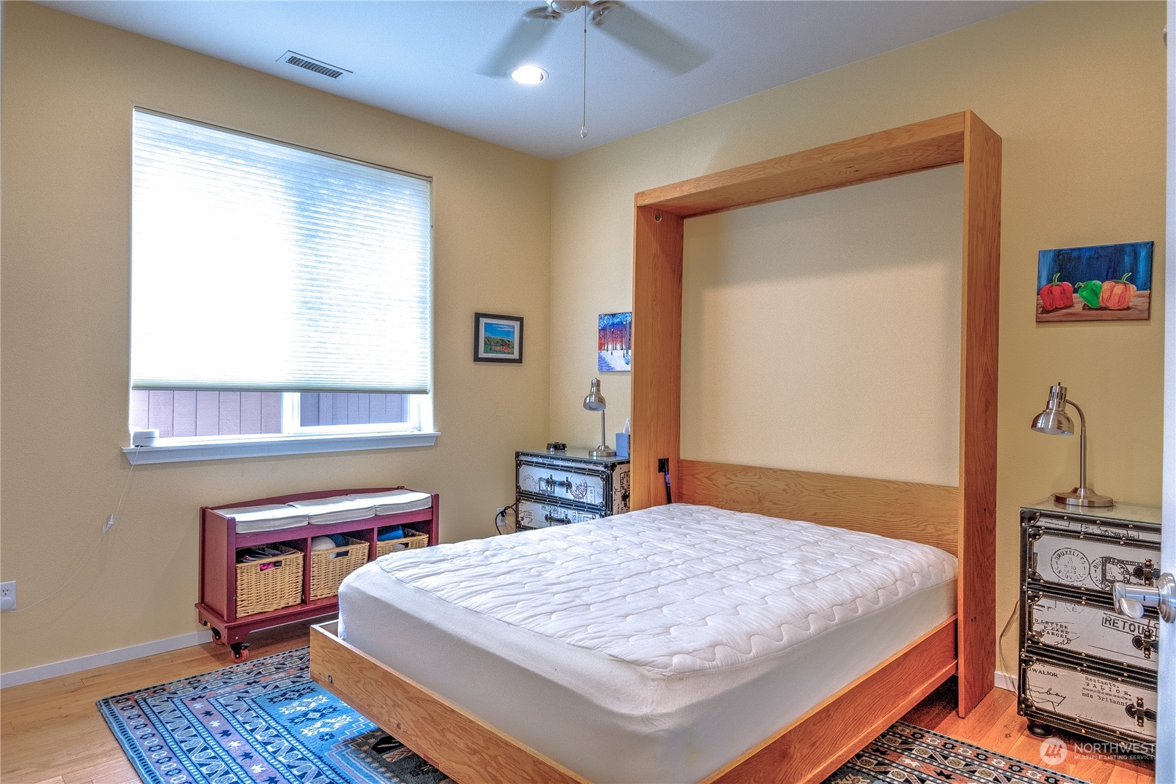 8024 Mercer Court Northeast Lacey, WA 98516 - Photo 18 of 30 a bedroom with a bed a table and a chandelier