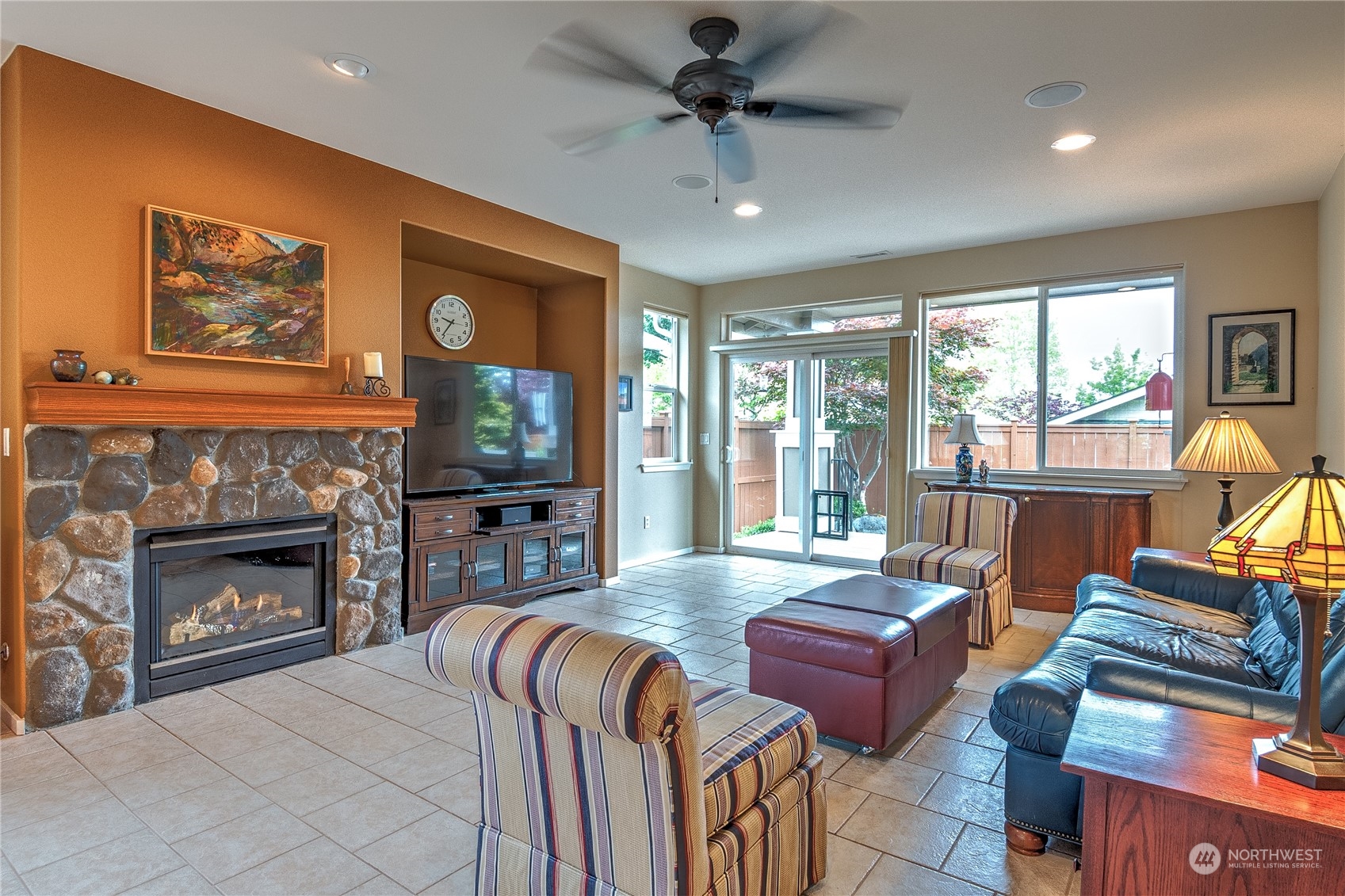 8024 Mercer Court Northeast Lacey, WA 98516 - Photo 2 of 30 a living room with furniture a flat screen tv and a fireplace