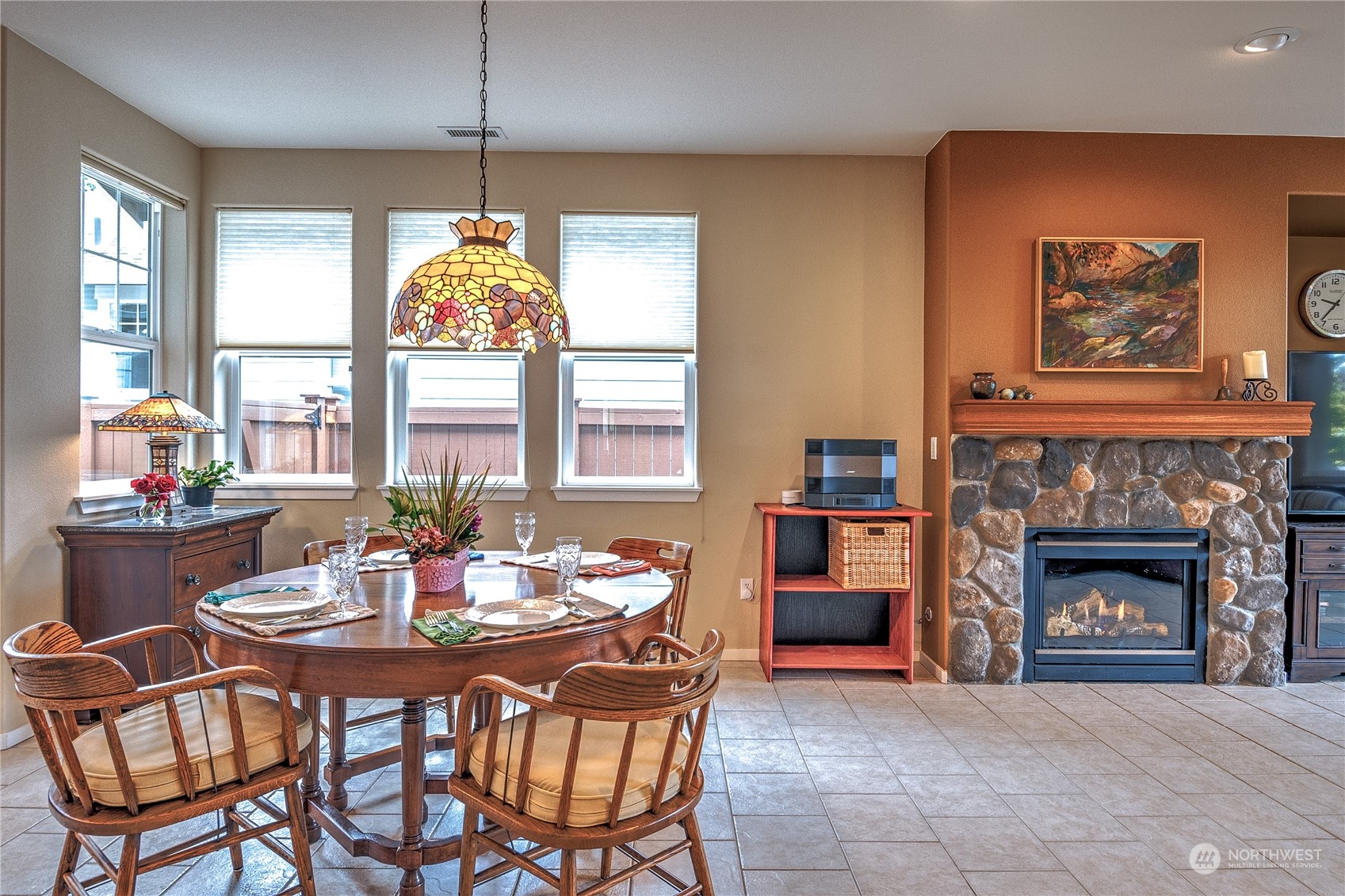 8024 Mercer Court Northeast Lacey, WA 98516 - Photo 3 of 30 a dining room with furniture and a fireplace