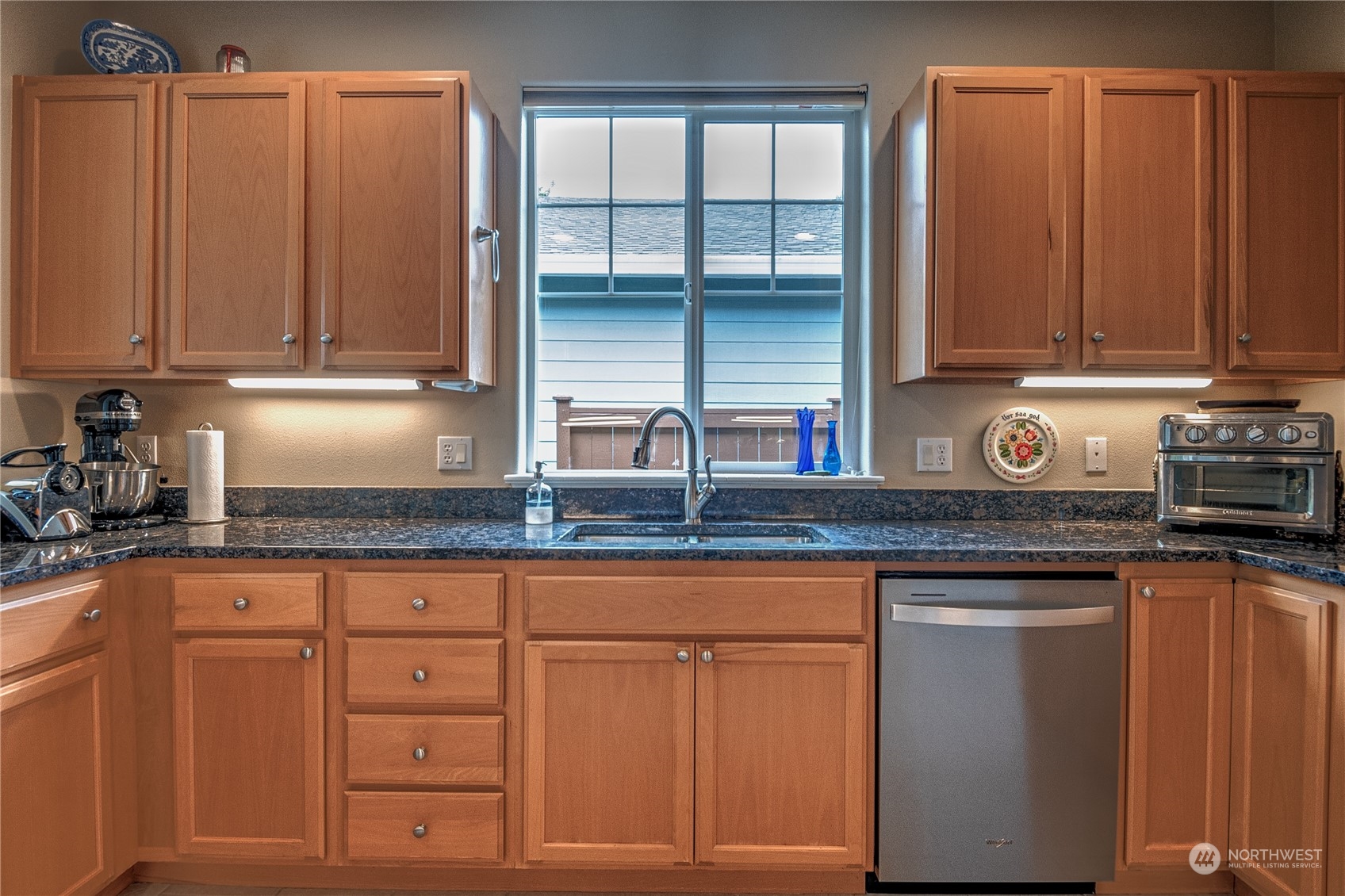 8024 Mercer Court Northeast Lacey, WA 98516 - Photo 6 of 30 a kitchen with granite countertop a sink a stove and cabinets