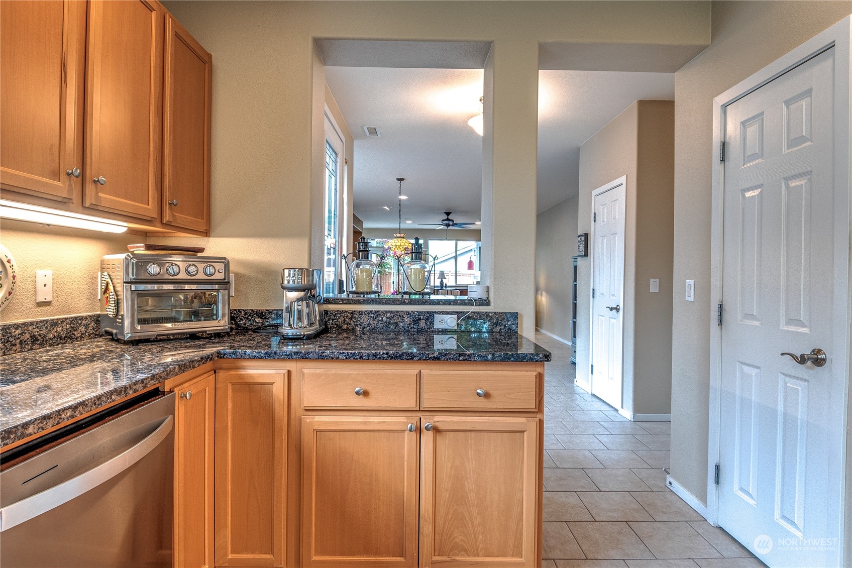 8024 Mercer Court Northeast Lacey, WA 98516 - Photo 8 of 30 a kitchen with granite countertop a sink stove and cabinets