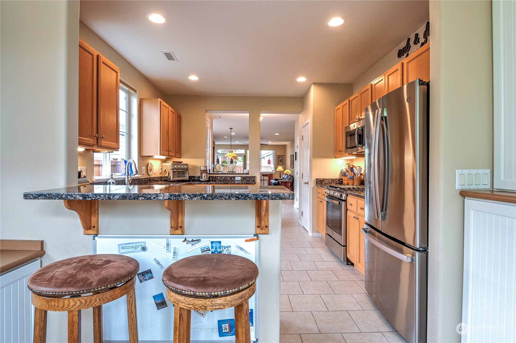 8024 Mercer Court Northeast Lacey, WA 98516 - Photo 9 of 30 a kitchen with stainless steel appliances granite countertop a refrigerator a sink and a stove