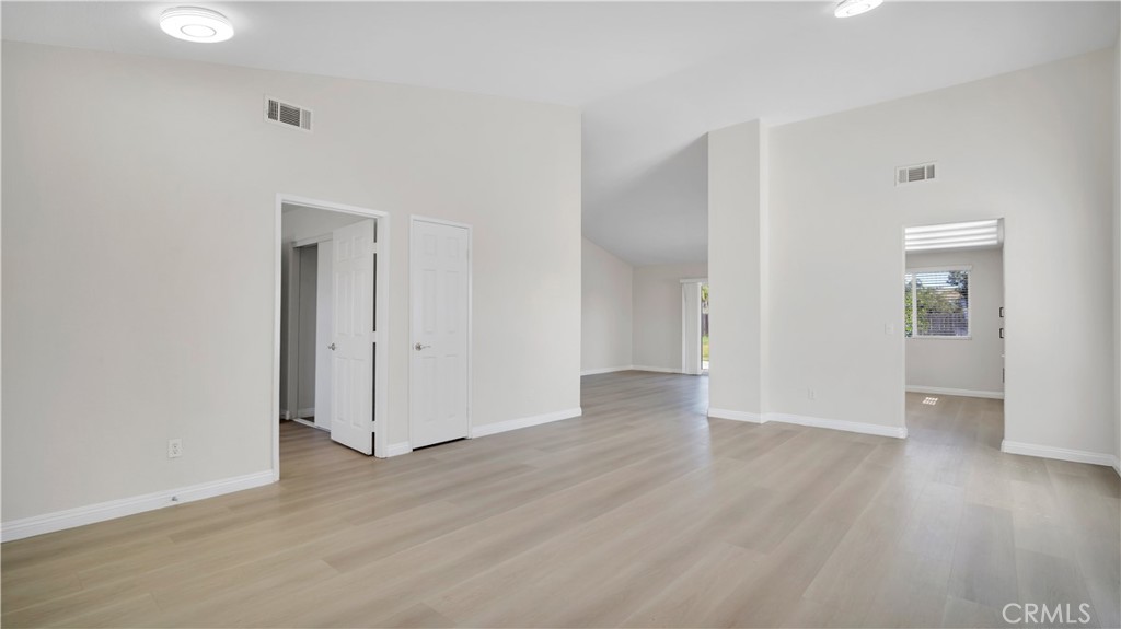 19364 Summerwind Trail Perris, CA 92570 - Photo 12 of 50 an empty room with wooden floor & windows
