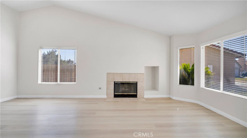 19364 Summerwind Trail Perris, CA 92570 - Photo 14 of 50 a view of an empty room with a window and fireplace