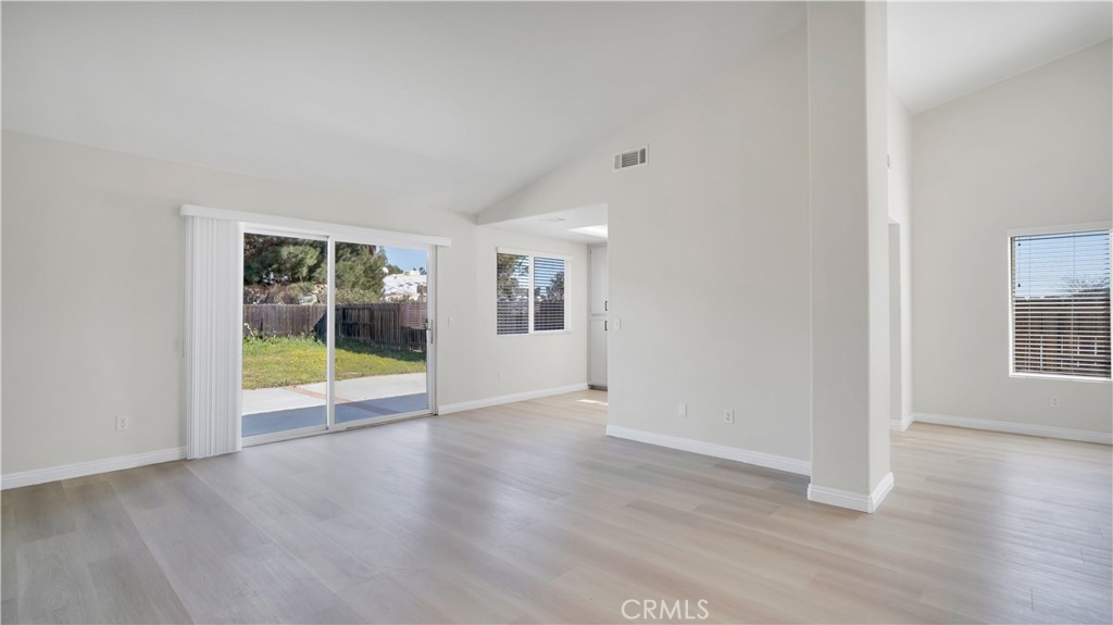 19364 Summerwind Trail Perris, CA 92570 - Photo 17 of 50 an empty room with wooden floor and windows