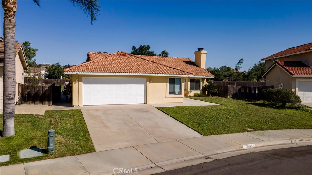 19364 Summerwind Trail Perris, CA 92570 - Photo 3 of 50 a front view of a house with a yard