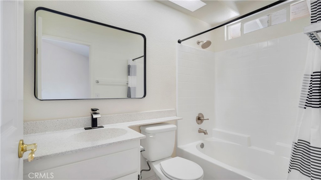 19364 Summerwind Trail Perris, CA 92570 - Photo 35 of 50 a bathroom with a sink a toilet and a mirror