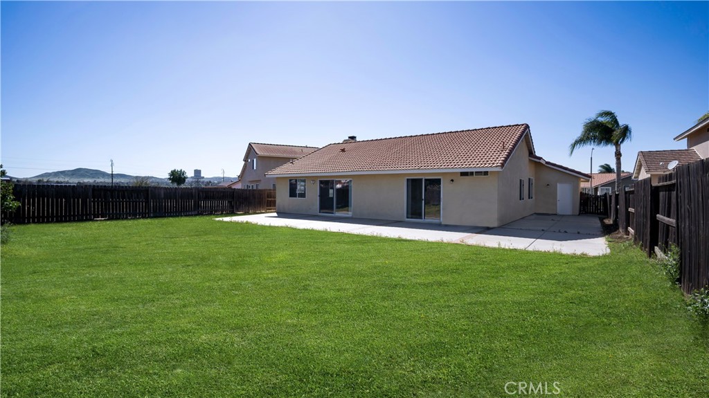 19364 Summerwind Trail Perris, CA 92570 - Photo 39 of 50 a front view of a house with garden