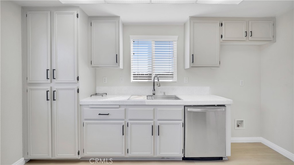 19364 Summerwind Trail Perris, CA 92570 - Photo 8 of 50 a kitchen with white cabinets and sink