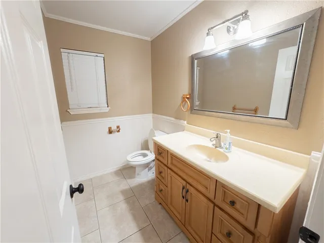 a bathroom with a sink a toilet and mirror