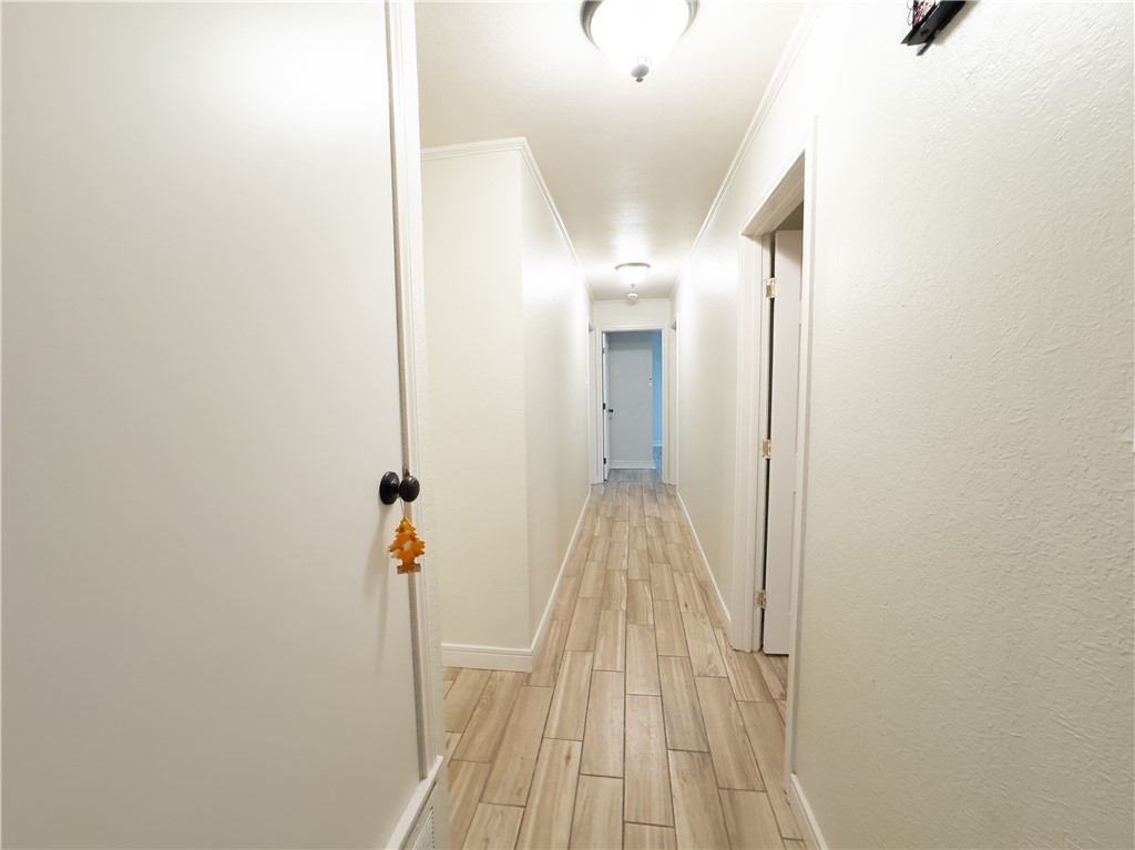 6702 Sahara Drive Corpus Christi, TX 78412 - Photo 12 of 30 a view of a hallway with wooden floor and staircase