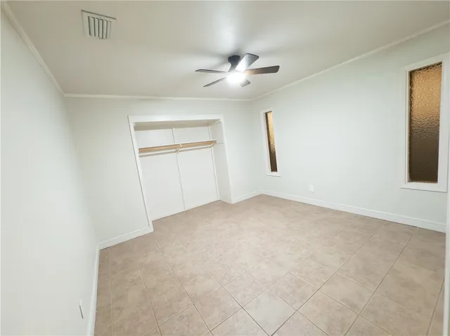 an empty room with windows and closet